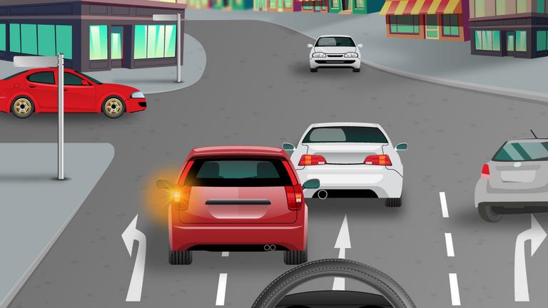 What should a driver do when continuing straight ahead in the middle lane?