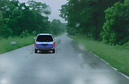 After a heavy downpour, why should a driver keep a greater distance from the vehicle in front?